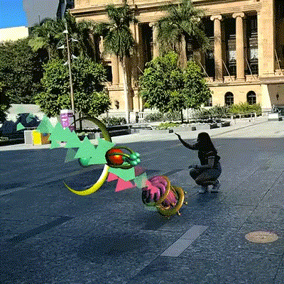 Person interacting with Artificial Ecology AR art outside