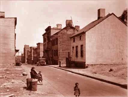 Sepia-toned archival photograph of a Brooklyn street with wooden buildings and children in the foreground